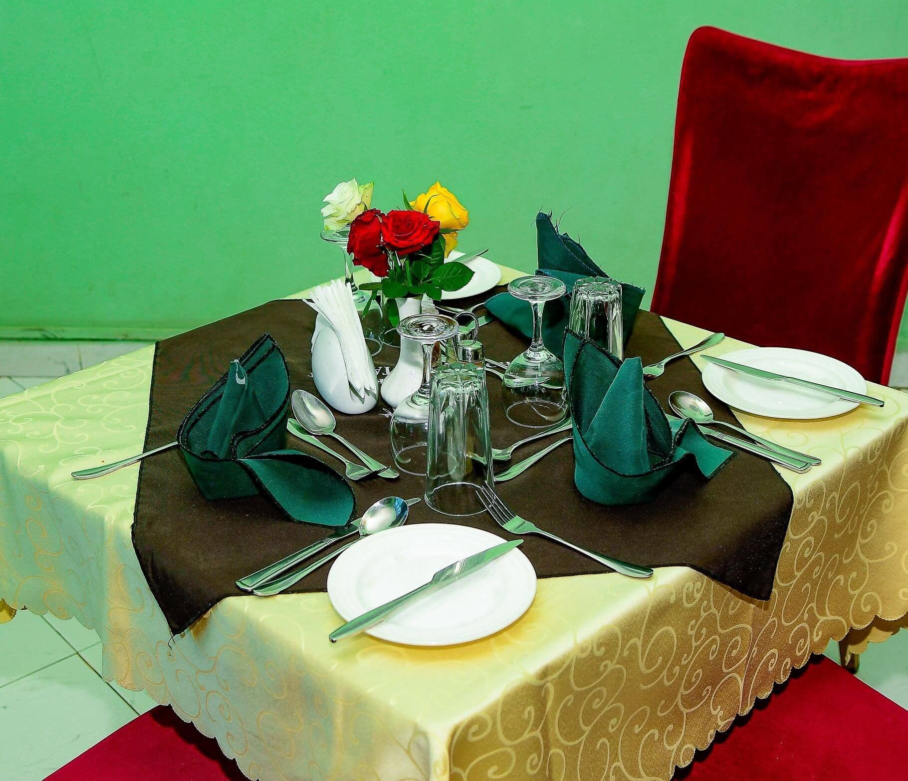 Table set for dinner with flowers at The Starbucks Hotel, Eldoret