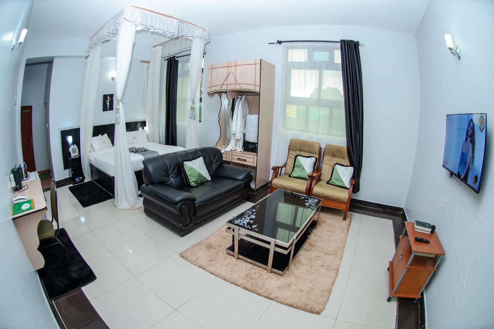 A sitting area with sofa and coffee table in a room at The Starbucks Hotel, Eldoret