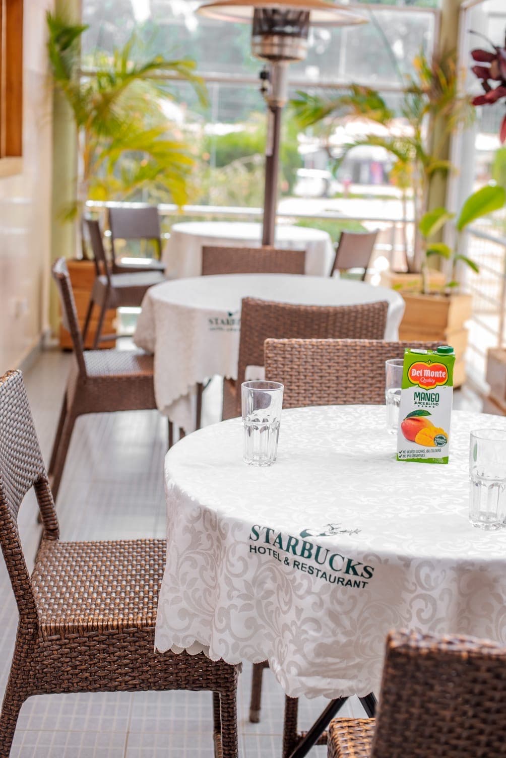 Sunlit terrace tables at The Starbucks Hotel restaurant, Eldoret