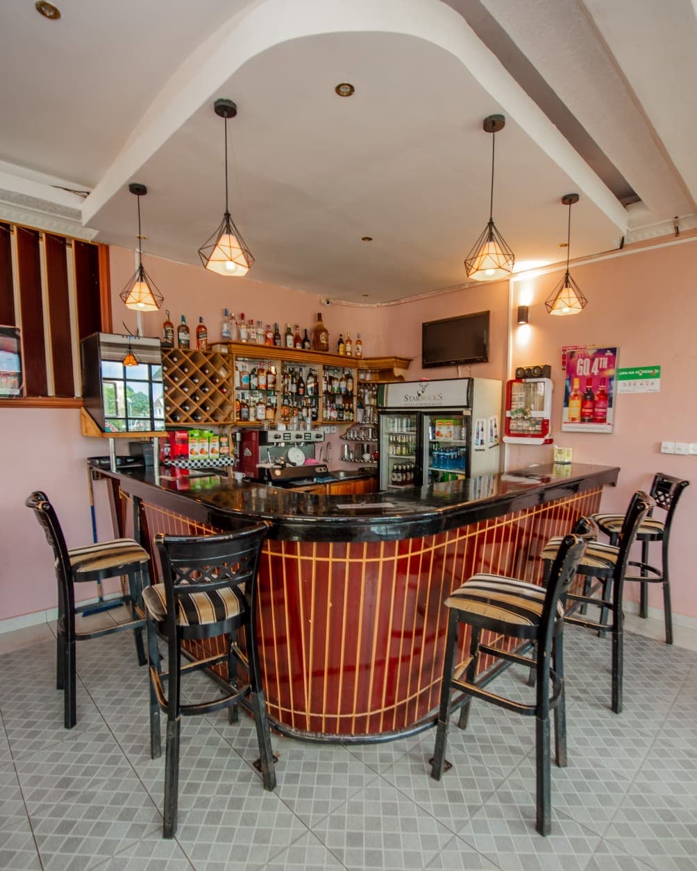Bar counter stocked with spirits at The Starbucks Hotel, Eldoret